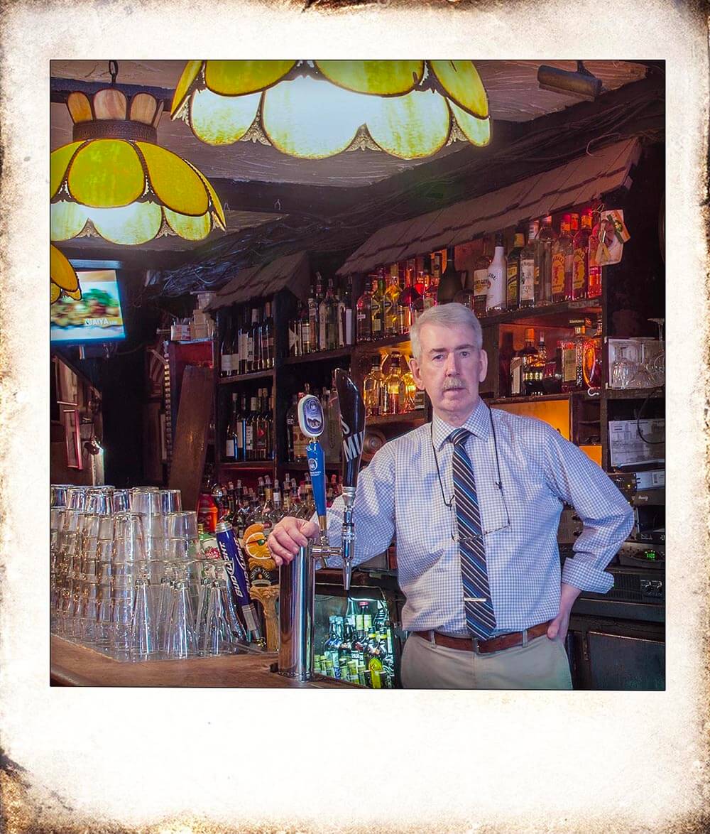a vintage picture of our bar with a man standing